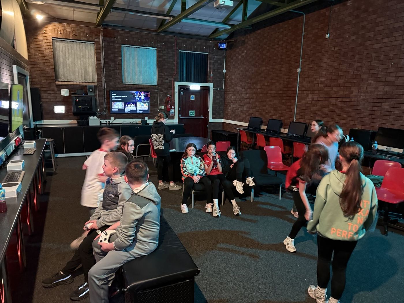 Members playing Xbox and Just Dance in the games zone