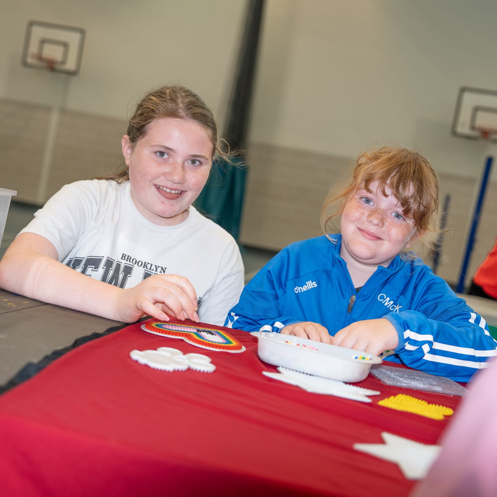 Five members arm in arm in the sports hall